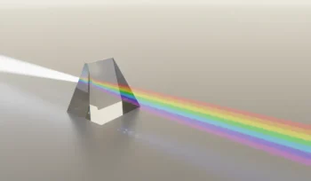 Glass prism refracting a white beam into a clean color spectrum on a neutral background, symbolizing personal brand clarity.