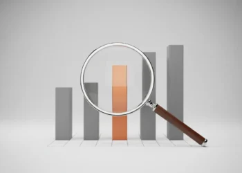 Magnifying glass highlighting a single standout bar on a minimalist chart, symbolizing insights from competitor research.